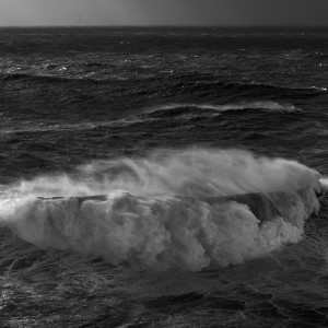 fine art black and white photo of the atlantic ocean during a big swell in Nazarè, Portugal
