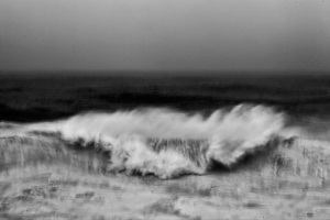Fine art black and white image of an abstract view of the ocean smashing into a cliff in Portugal, Nazaré, north canyon. big wave surf