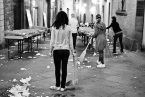 Fine art black and white photography of people in the street of Siena drinking wine after the Palio 2014