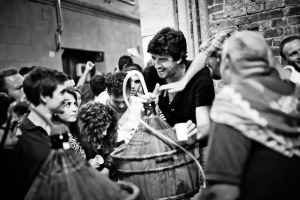 Black and white fine art photography of people in the street of Siena drinking wine after the Palio