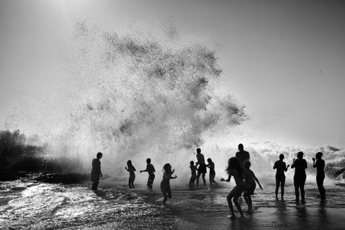 fine art image in blafine art image in black and white of people enjoying the ocean, awarded balck and white spider awardsck and white of people enjoying the ocean