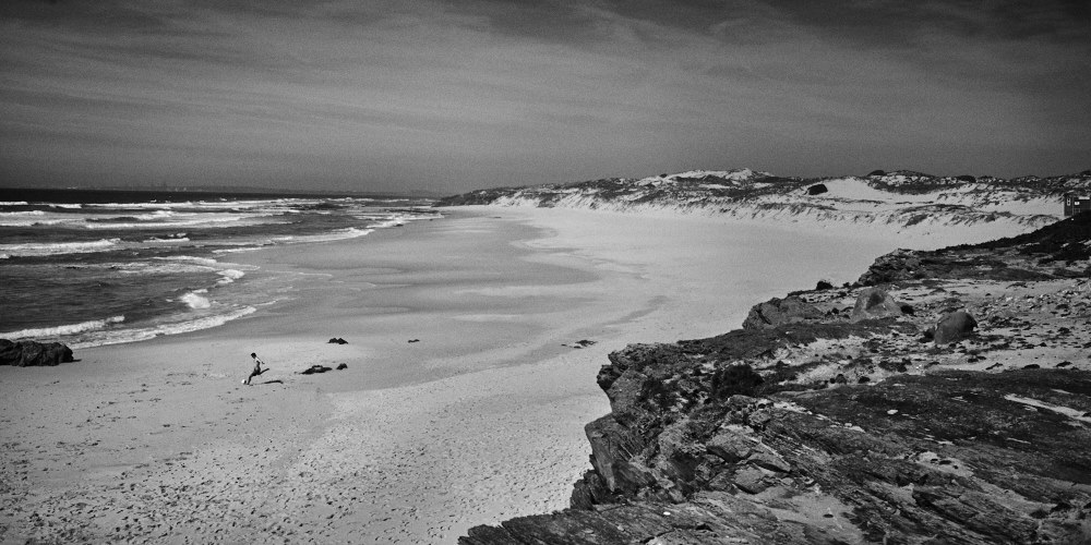 finer black and white photograph of a beach named Praia do Malhào in Portugal