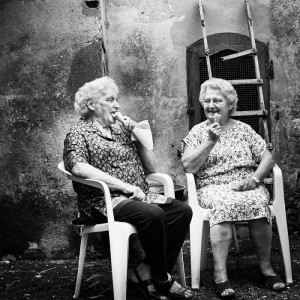 Fine art black and white image of two ladies in tuscany eating icecream