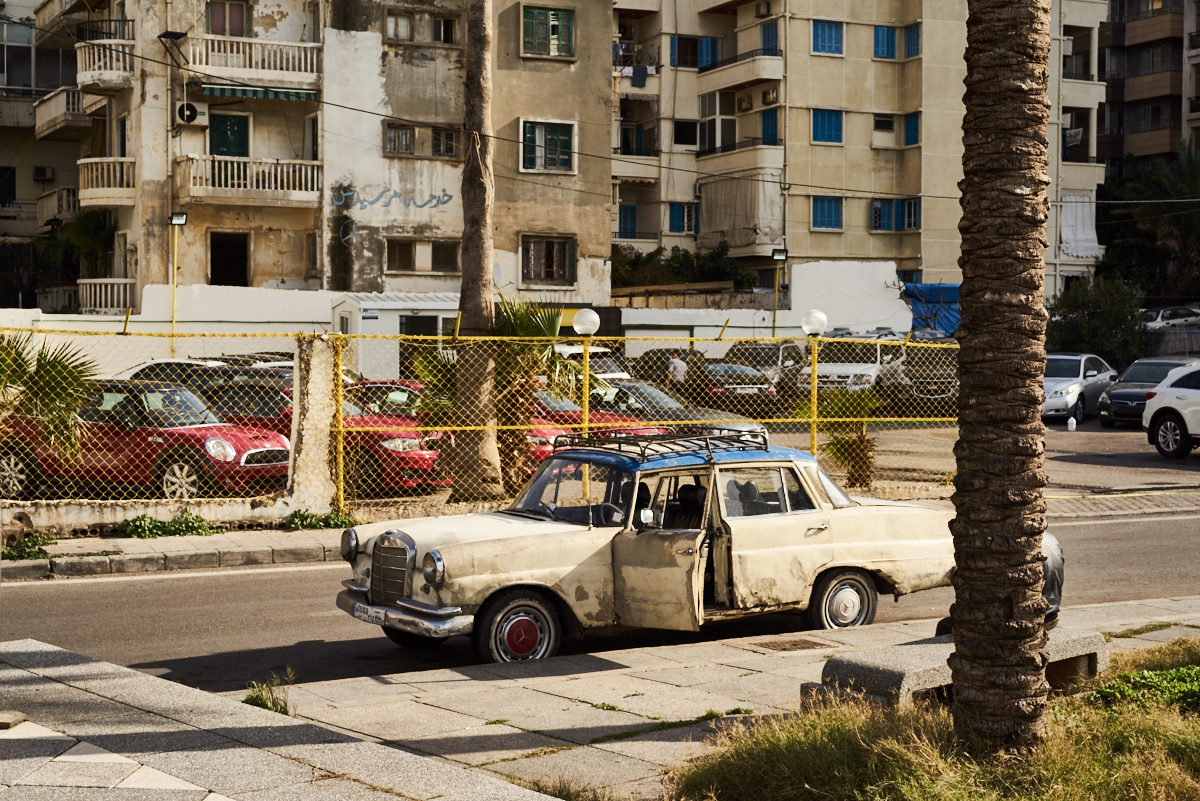 fine art image in Beirut of an old car next to new shinny ones