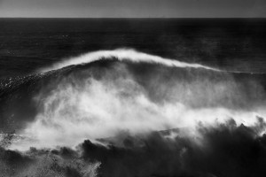 classic fine art black and white seascape of a huge wave in Nazaré, Portugal