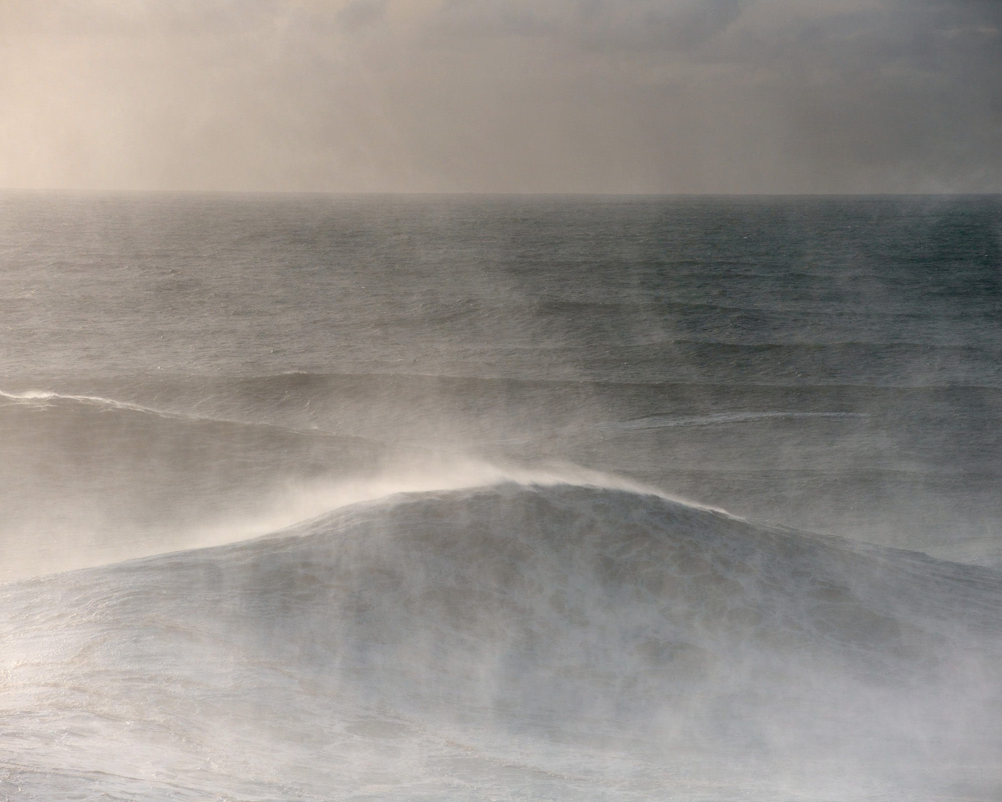 Sunset in the Atlantic sea in Nazaré during a big winter swell